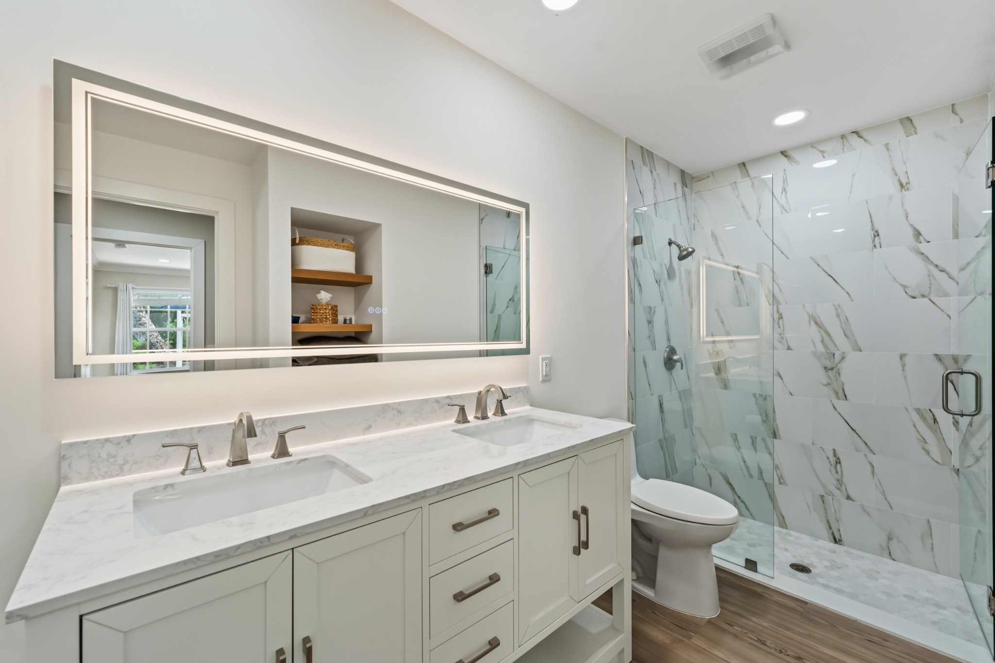 Updated bathroom with double vanity and glass shower at 8437 SE Retreat Drive